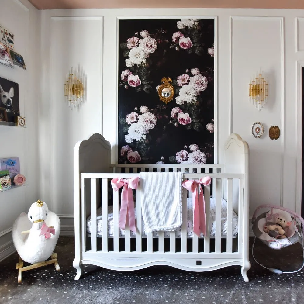 Nursery with bold floral wallpaper panel