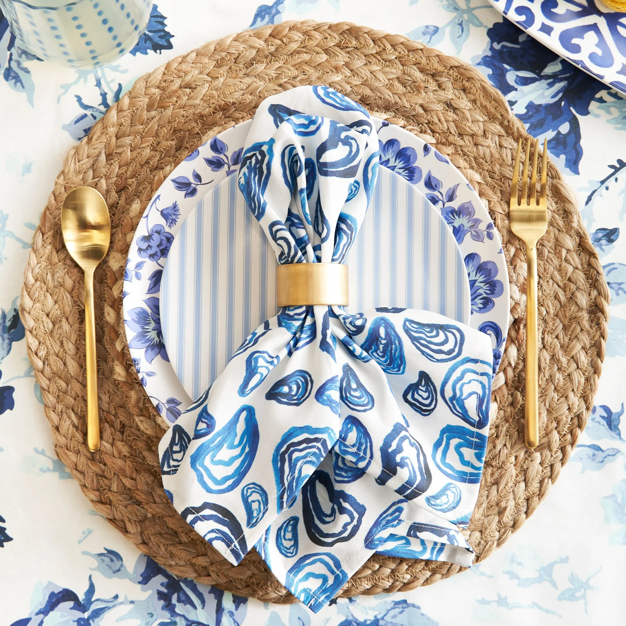 Oyster pattern dinner napkin in napkin ring on dining table