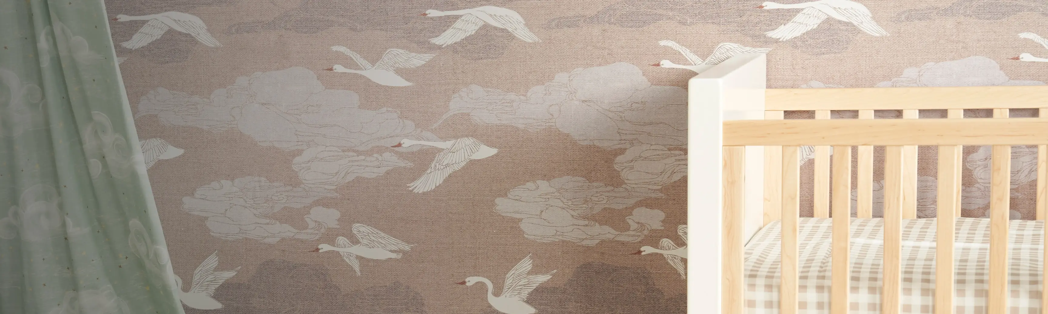 Nursery with swan print wallpaper