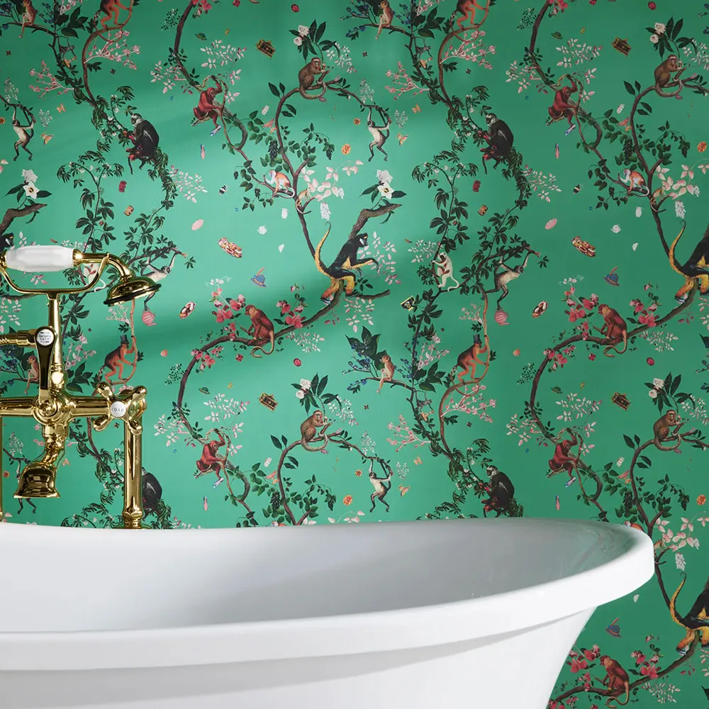 Bathtub with teal wildlife wallpaper behind it