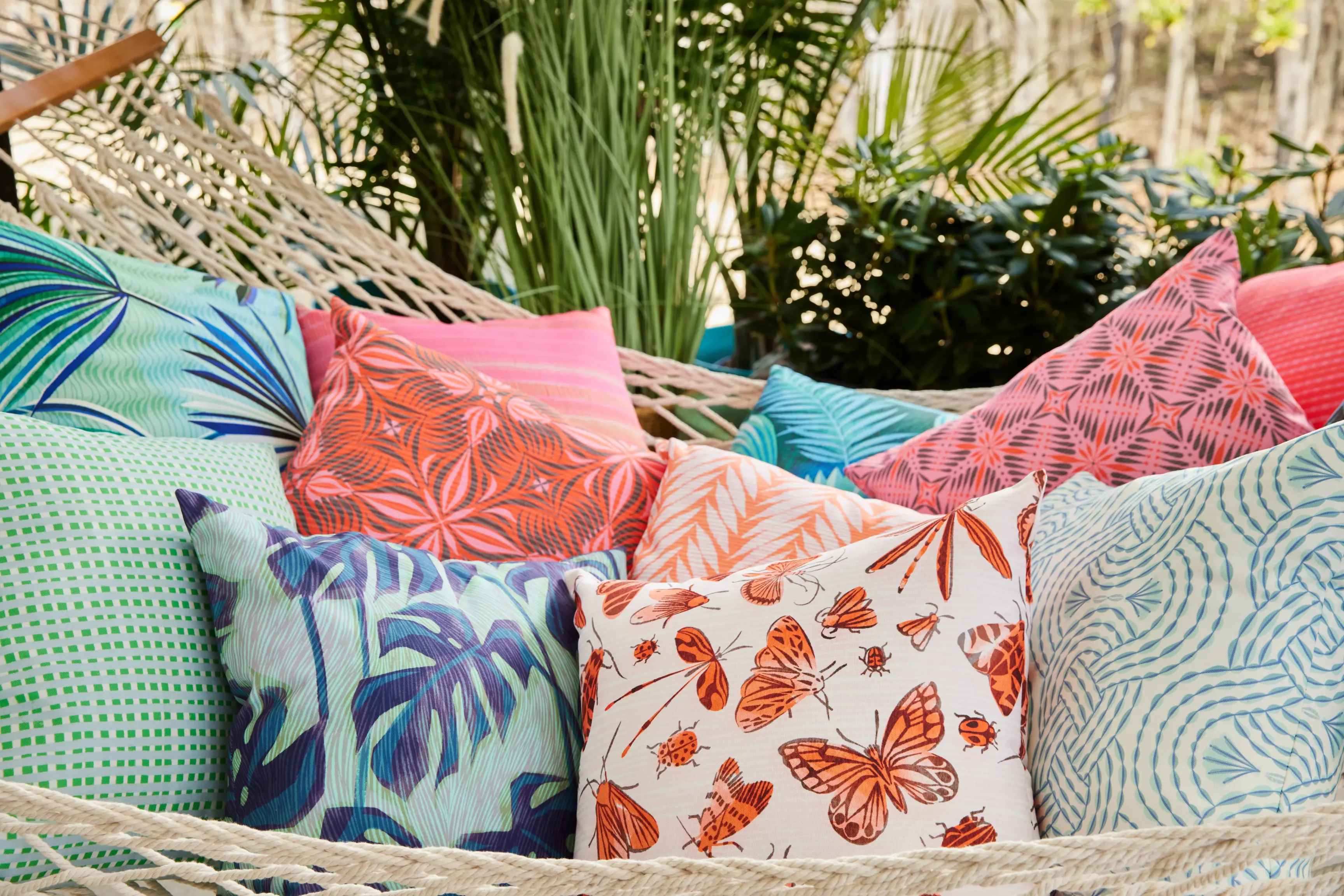 Summery colorful square throw pillows in hammock