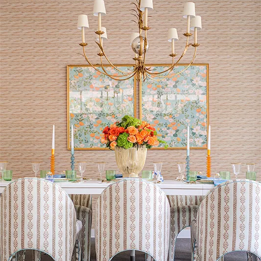 Grasscloth wallpaper in a dining area with upholstered chairs.