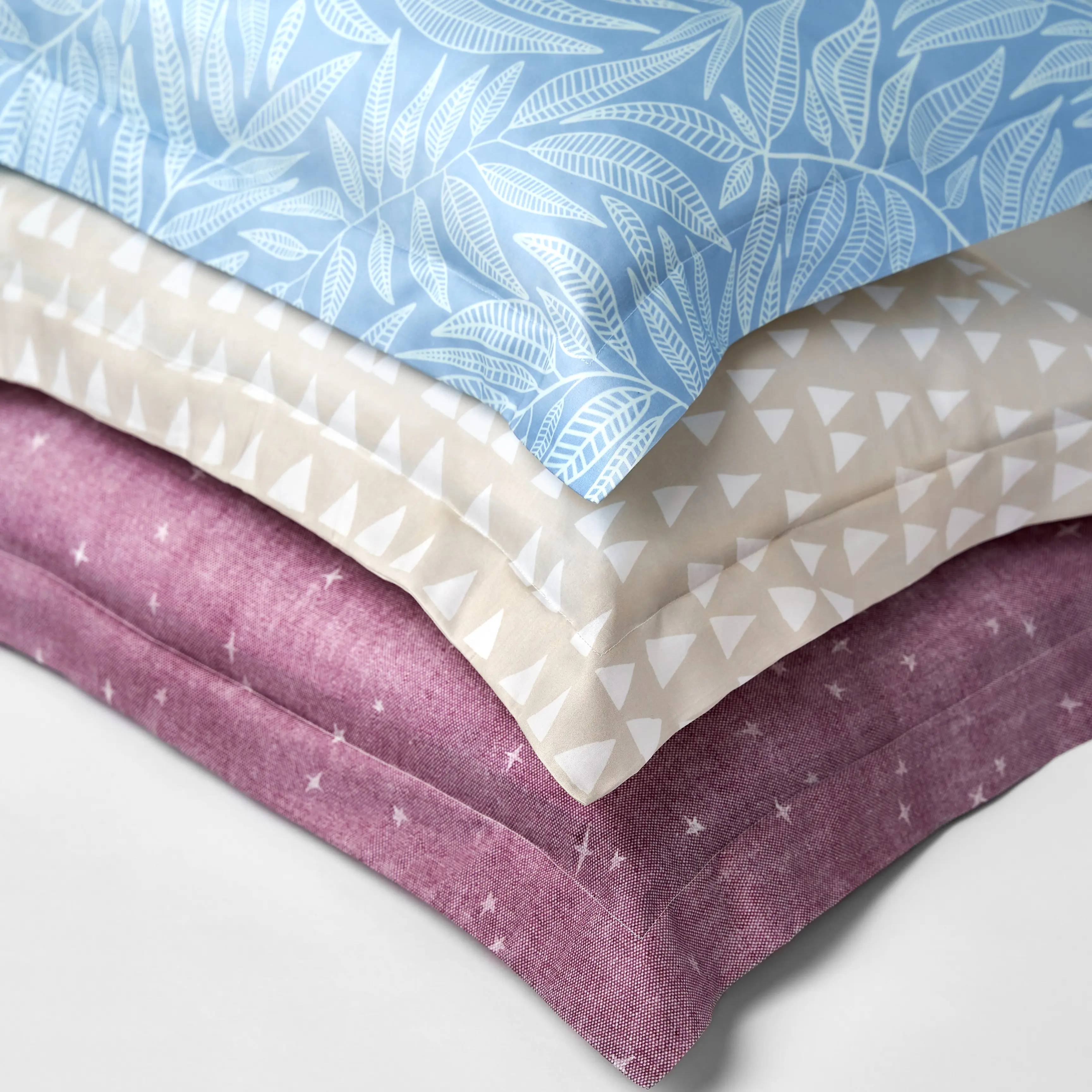 Stack of three flanged pillow shams